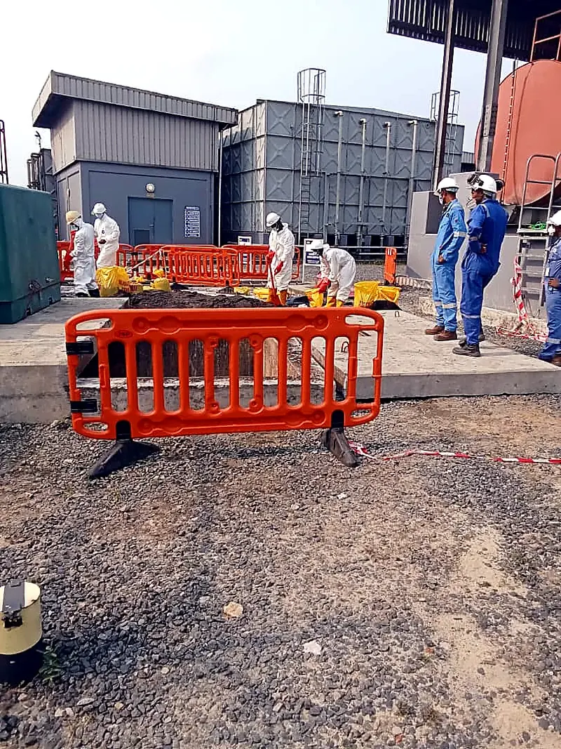 Orange safety barriers around a work area at an industrial site